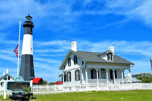 Tybee Island Lighthouse 154-foot tower with black and white daymark, keeper's cottages, and Atlantic Ocean views