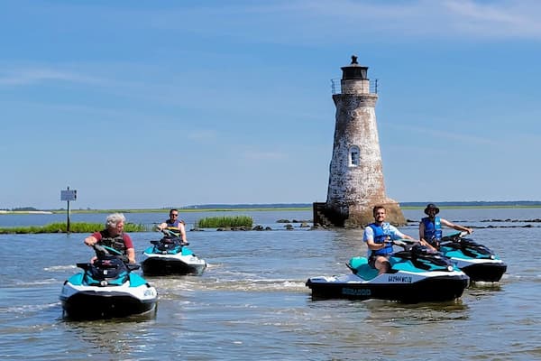 Tybee Island water sports kayakers and paddleboarders in salt marshes with dolphin spotting opportunities